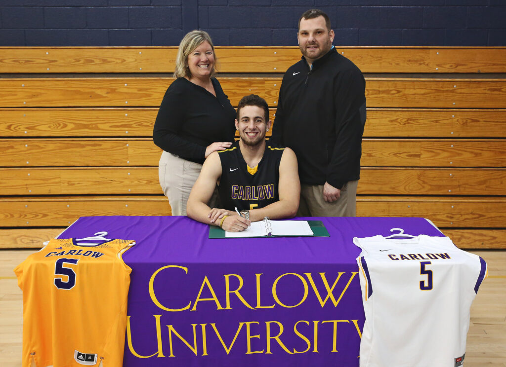 Photo of Tony Acrie, along with Sue Brugh and Landon Loya, as Tony commits to play basketball at Carlow University
