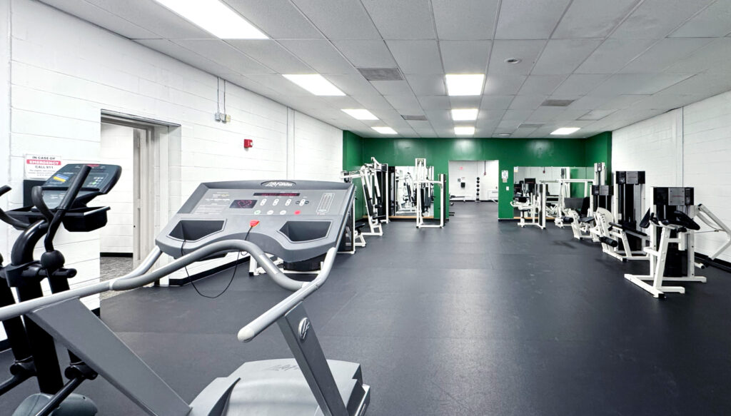 Photo of the inside of the Black Bear Fitness Center, showing cardio and weight equipment