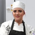 Posed photo of Trinity Hyatt in her chef gear, in the Culinary Center.