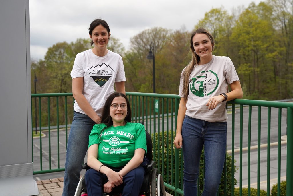 Decorative image. Three female students standing outside