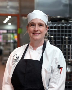 Kat Walker, chef student, posing in the Culinary Center.