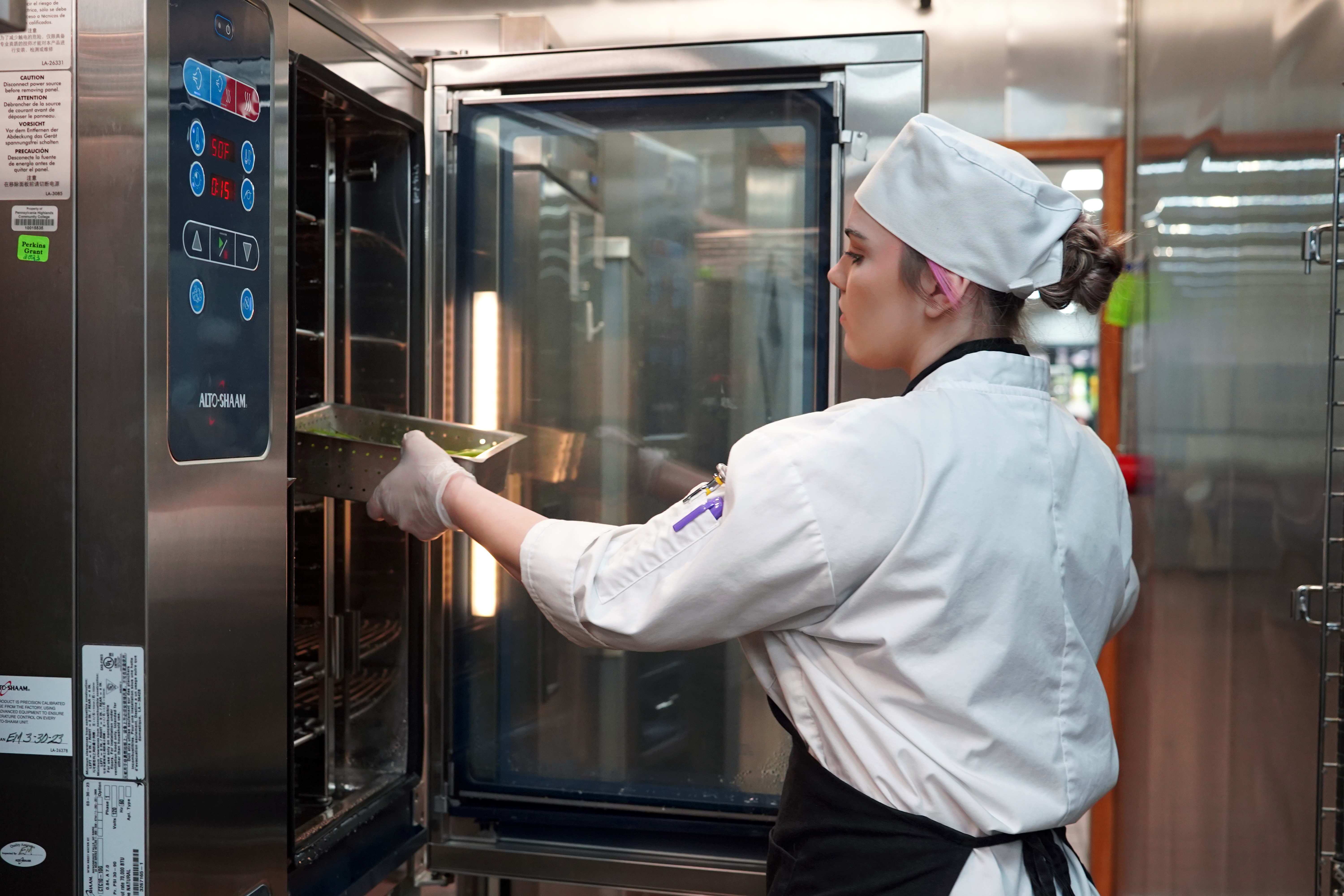 Trininty Hyatt, chef student, getting vegetables out of the cooler in the culinary kitchen.